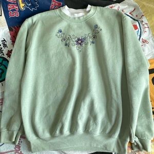 Oversized sea foam crewneck with floral embroidery.